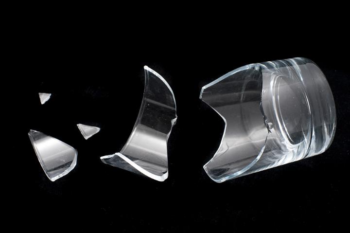 Shattered Concept - Close up Broken Glass Isolated on Black Background with Copy Space for Text.