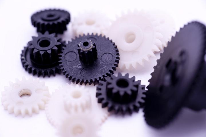 Team Work Concept - Close up Black and White Gears on White Background.