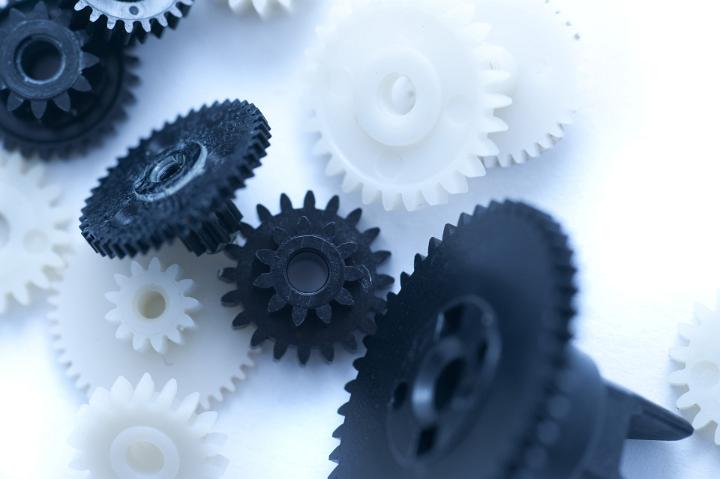 Close up Black and White Gears on White Table for an Unorganized Concept
