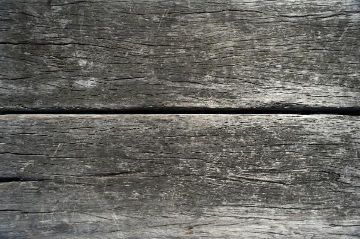 Background texture of old rough weathered wooden boards with a central join in full frame view