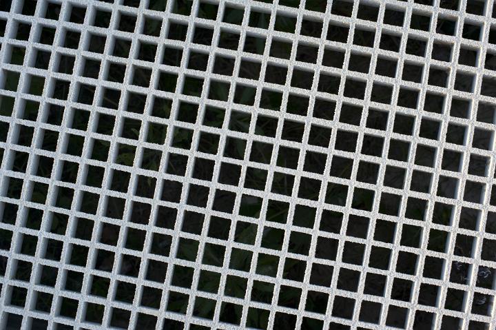 Bold white lattice background pattern with equilateral geometric squares over a black background