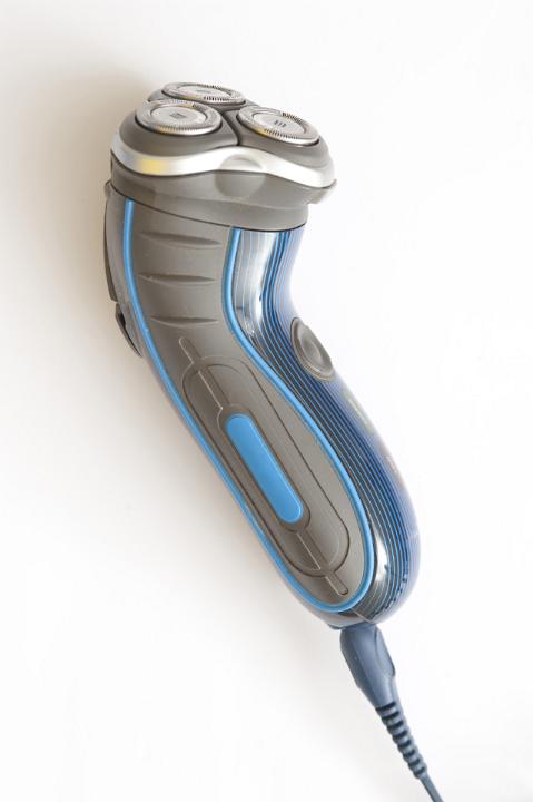 Close Up Still Life of Blue and Grey Electric Razor for Shaving on White Background from Above