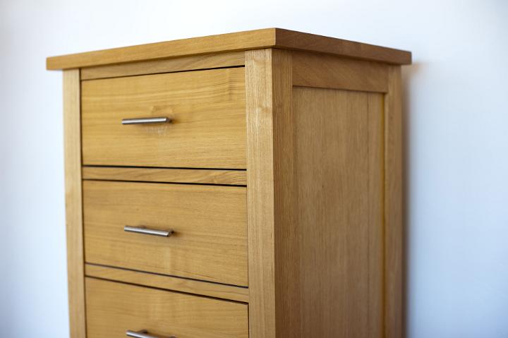 Close up Simple Design of Brown Wooden Drawer Chest Furniture on White Wall Background.