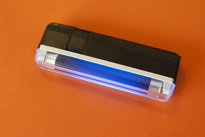 UV lamp with an ultraviolet tube emitting electromagnetic radiation between 4 and 400nm used to detect fluorescence from pathogens or in security from special marker inks