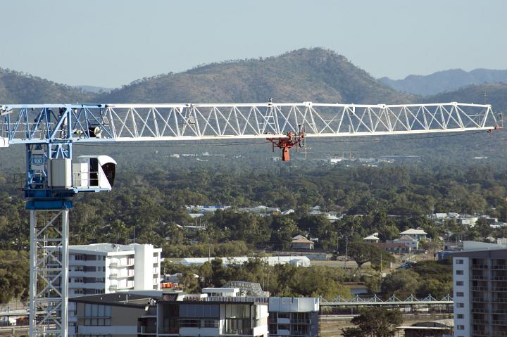 Industrial crane at an urban building site viewed at the level of the cab with the boom arm in the horizontal position