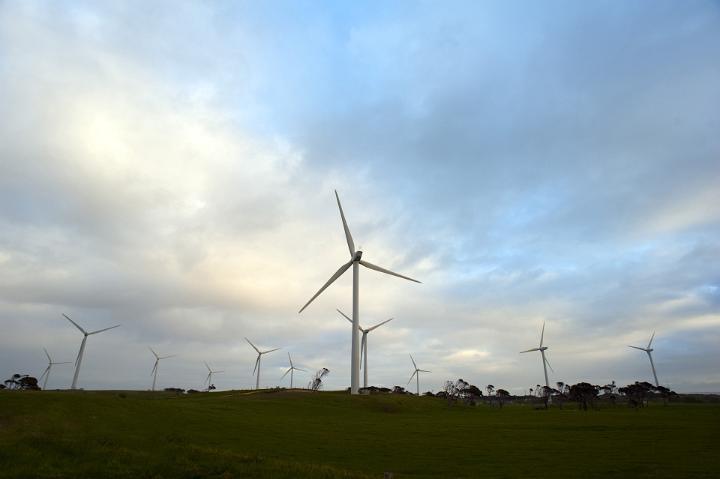 Wind turbines on a wind farm supplying energy and power from natural resources through the conversion of the kinetic energy of the wind, rural landscape
