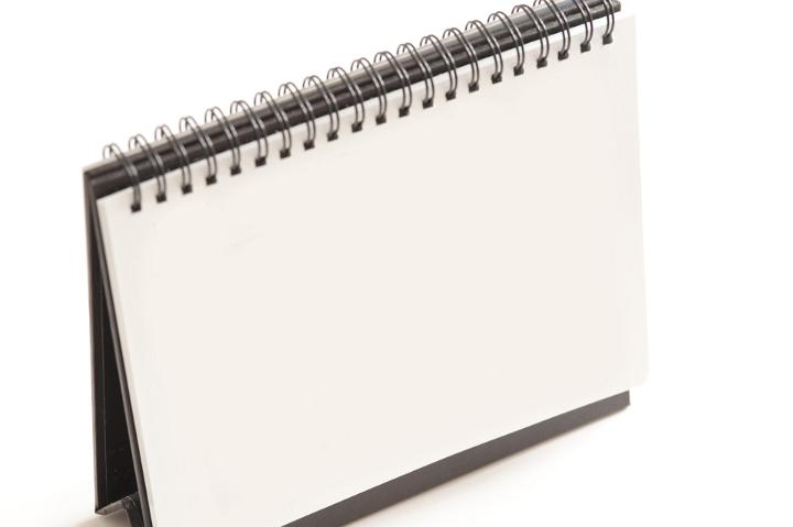 Close up Standing White Spiral Blank Flip Chart Isolated on White Background, Emphasizing Copy Space.
