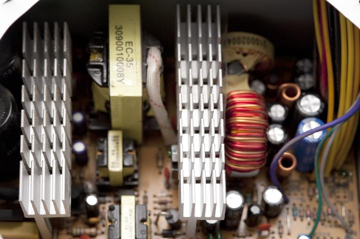Components inside a  switching power supply, heatsinks and filter inductors, these PSUs are more efficient than older linear regulator units