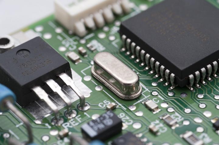 A quartz Clock Crystal - in metal can in centre of image - used to create a stable clock signal for a microprocessor