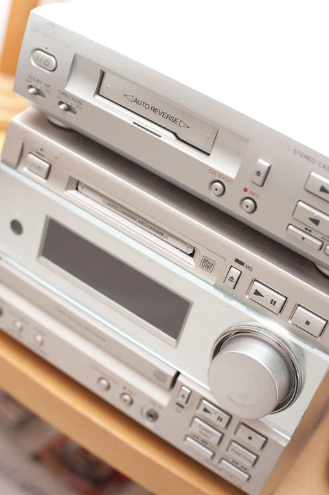 Compact modern silver hifi unit with a DVD and tape deck, angled close up view