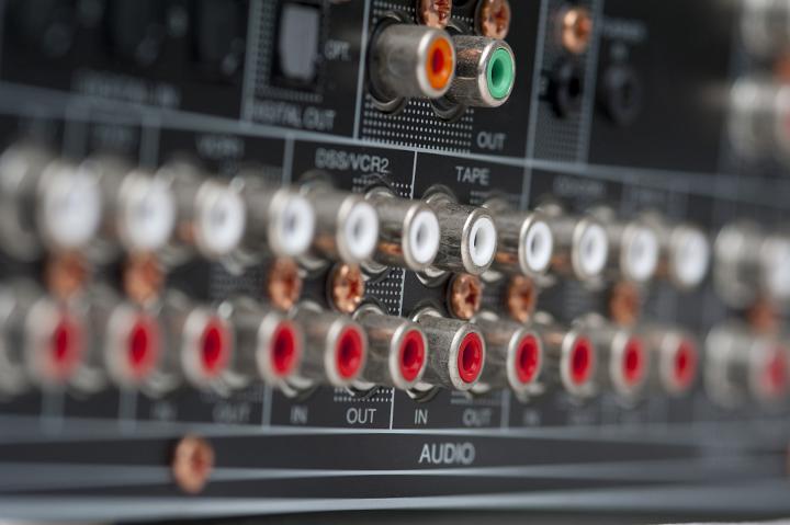 an array of RCA phono stereo audio connections on the back of an amplifier