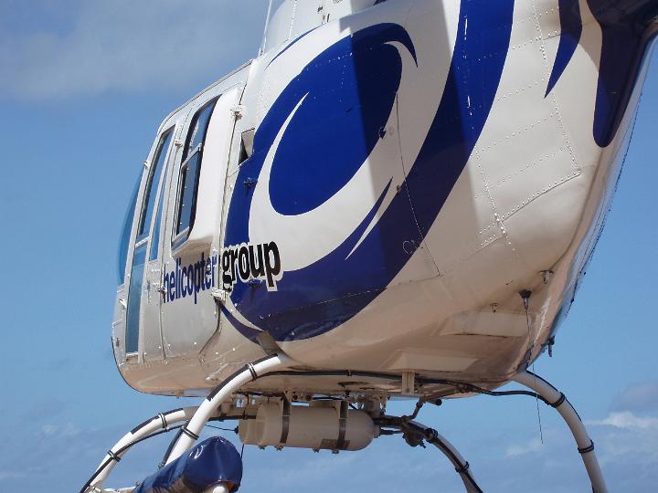 Close Up of Blue and White Helicopter Shot from Behind and Below