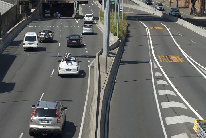 Cars traveling along an urban road with underpass tunnel, concept of commuting and city transport flowing freely