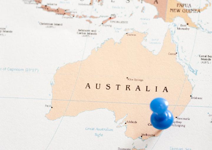Close Up of Map of Australia with Blue Pin Inserted into Location on East Coast Near Sydney