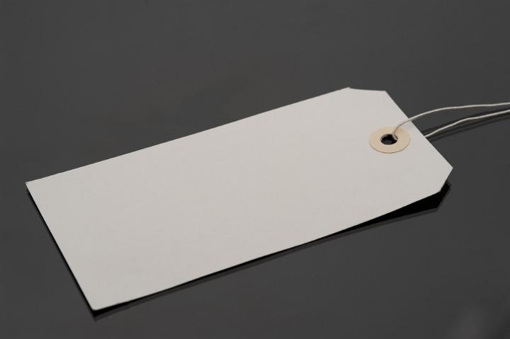 Close Up of Blank Luggage Tag with String on Dark Grey Background, Copy Space for Personalization