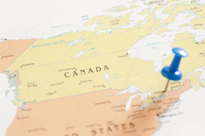 Blue Thumb Tack Pinned into Location of City of Ottawa on Map of Canada as if Planning Trip