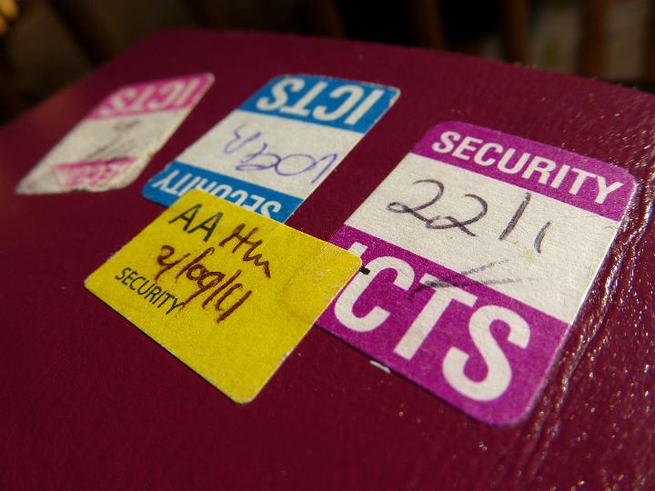 Security stickers aded to a passport to confirm the passenger has been checked by security