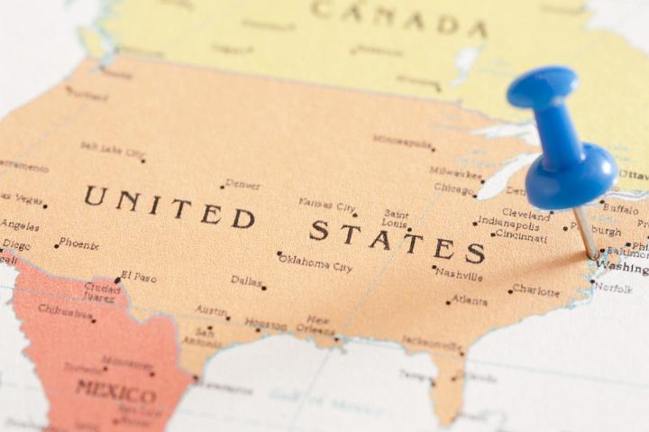 Close Up of Blue Thumb Tack Pinned into Location of Washington on Map of United States of America