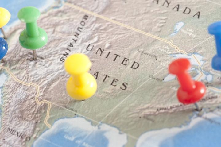 US Travel Concept - Close up Shot of Conceptual Three Colored Pins on United States Map.